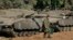 FILE - An Israeli soldier walks past tanks near the Israel and Gaza border, July 10, 2014. The United States and Israel are negotiating a new deal regarding military aid.