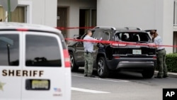 Forensic technicians work on the vehicle that authorities say breached security at President Donald Trump's Mar-a-Lago resort in Palm Beach, Florida, Jan. 31, 2020.