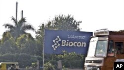 Traffic moves outside the main premises of Biocon, an Indian biotech company, in Bangalore, India, 17 Dec 2010