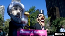 Members of advocacy group Avaaz take part in a protest wearing masks outside the UN headquarters. September 24, 2013. 