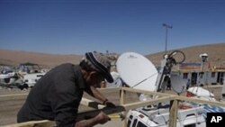 A carpenter working for a media outlet builds a riser at the San Jose Mine near Copiapo, Chile, Thursday Oct. 7, 2010