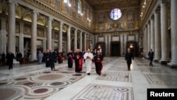Newly elected Pope Francis (C), Cardinal Jorge Mario Bergoglio of Argentina, walks in the 5th-century Basilica of Santa Maria Maggiore during a private visit in Rome, March 14, 2013.