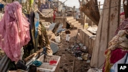 A young girl walks in the Kaweni slum on the outskirts of Mamoudzou, in the French Indian Ocean island of Mayotte, Dec. 19, 2024, after Cyclone Chido.