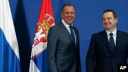Russian Foreign Minister Sergey Lavrov, smiles during an appearance with his Serbian counterpart Ivica Dacic (right) in Belgrade, Serbia, Dec. 12, 2016. Lavrov is on a two-day official visit to Serbia.