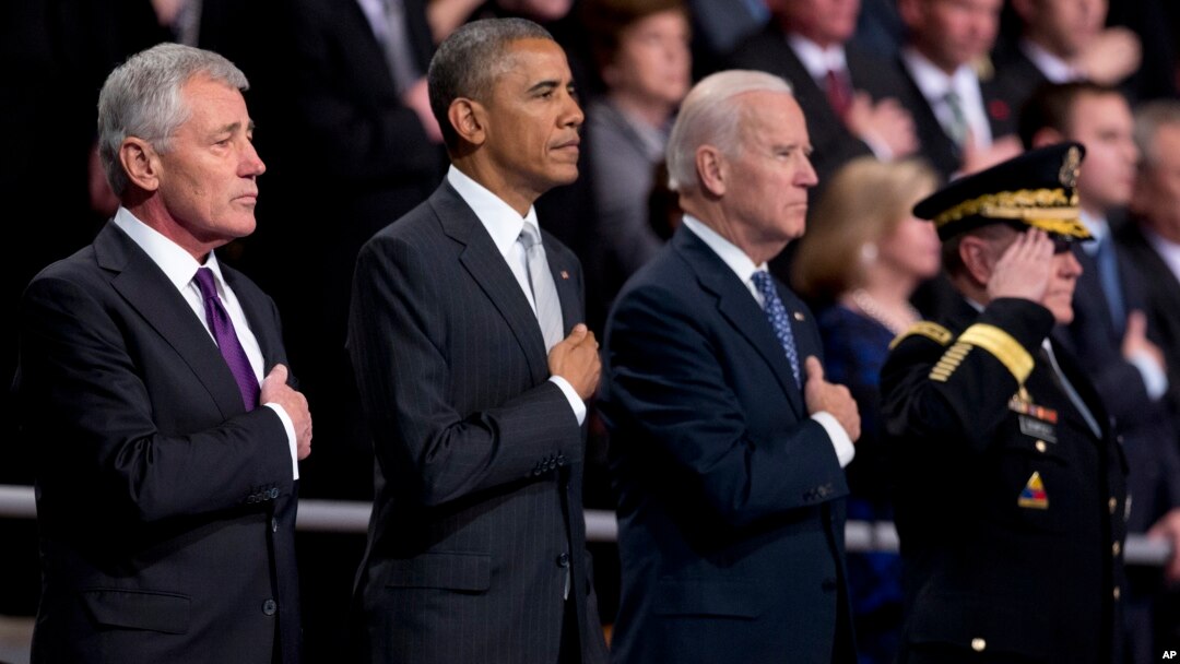 From left, outgoing Defense Secretary Chuck Hagel, President Barack Obama, Vice President Joe Biden and Joint Chiefs Chairman Gen. Martin Dempsey listen to the national anthem during a tribute to Hagel at Fort Myer in Arlington, Virginia., Jan. 28, 2015.