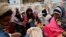 People browse through street vendors' stalls selling winter clothes in Dhaka on Dec. 21, 2019.