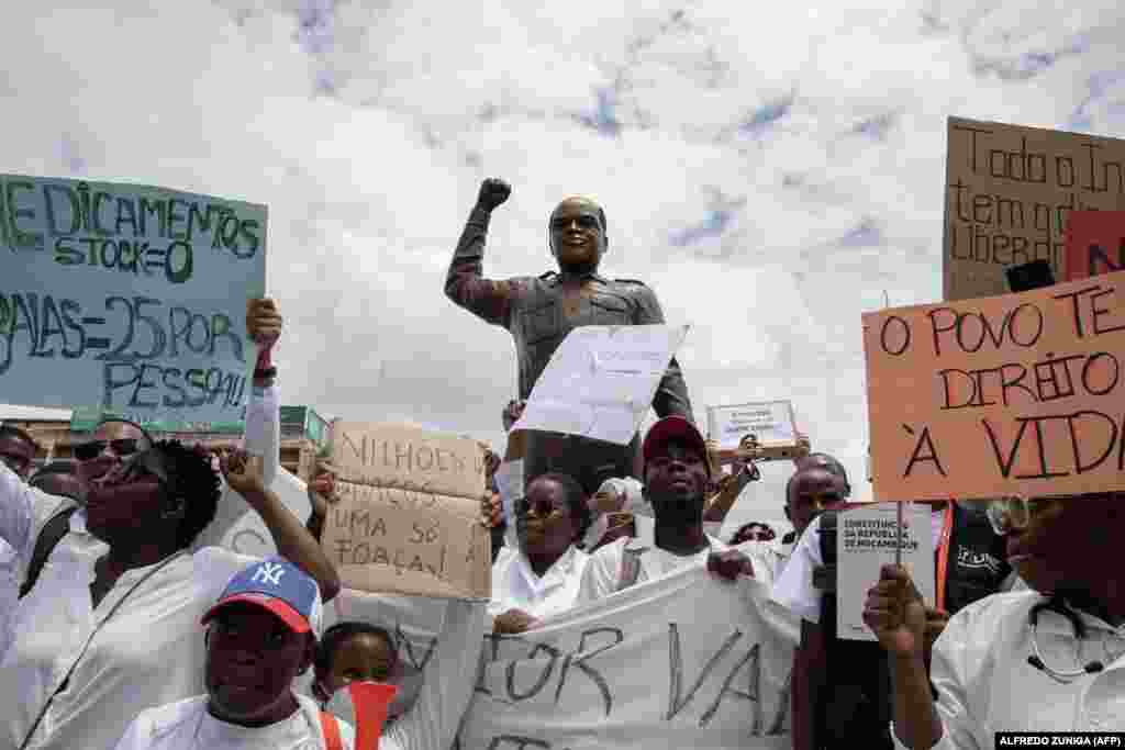 Membros da comunidade médica em Moçambique marcham em Maputo, junto à estátua Eduardo Mondlane, contra a violação dos direitos humanos no país