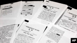 A sample of classified Chinese government documents leaked to a consortium of news organizations, is displayed for a picture in New York, Nov. 22, 2019. 