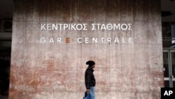 A man walks in front of central train station during a 24-hour nationwide general strike, in Athens, Thursday Nov. 27, 2014.