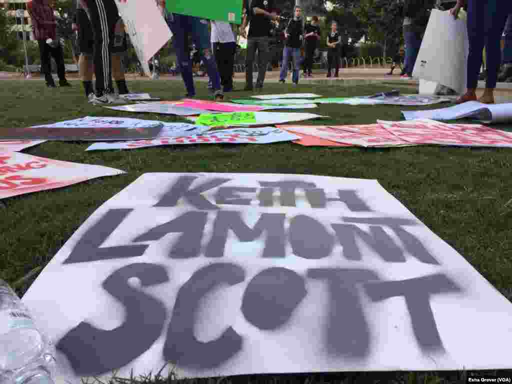 Protesters gather in Romare Bearden park, encouraging others to take a sign and join the march, in Charlotte, North Carolina, Sept. 22, 2016. Demonstrators gathered for a third night in Charlotte, following the police shooting death on Tuesday of Keith La