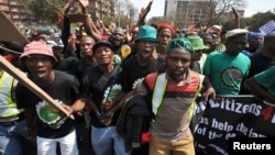 Miners from Marikana, along with their families and supporters, march to the Union Buildings in Pretoria, to protest the government's lack of legal funding for the Marikana commission of inquiry, Sept. 12, 2013.