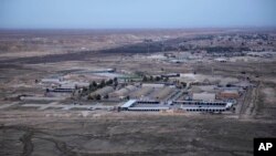 This aerial photo taken from a helicopter shows Ain al-Asad air base in the western Anbar desert, Iraq, Sunday, Dec. 29, 2019. An Iraqi general said Sunday that security has been beefed up around the Ain al-Asad air base, a sprawling complex that hosts U.S. forces