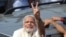 India's main opposition Bharatiya Janata Party’s prime ministerial candidate Narendra Modi displays the victory symbol to supporters after casting his vote in Ahmadabad, India, April 30, 2014. 