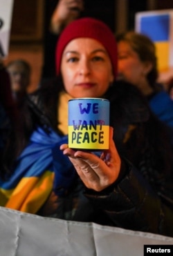 People take part in a silent candlelight vigil to show their support of Ukraine on the eve of the war's anniversary, in New York City