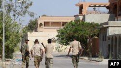 Fighters from the pro-government forces loyal to Libya's Government of National Unity (GNA) walk on August 3, 2016 in Sirte.