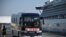 A bus with “Go, we go back to home” on the front transfers passengers from the Diamond Princess in Yokohama, Feb. 21, 2020. Hundreds of people have left the ship after testing negative for the disease and many have returned home and further quarantine.