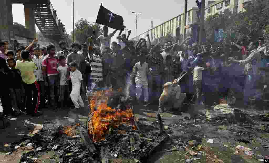Christians chant slogans as they burn materials during a protest against a suicide attack on a church, Sept. 22, 2013 in Karachi, Pakistan. 