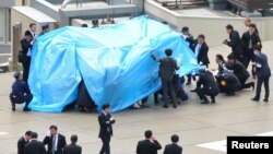 22일 일본 도쿄 총리 관저 옥상에서 발견된 정체불명의 무인기를 경찰과 보안 요원들이 조사하고 있다.