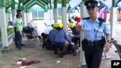 This frame grab from video provided by iCable TV, shows a victim receiving medical treatment at the Quarry Bay Park in Hong Kong, June 26, 2018. 
