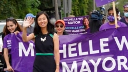 FILE - Boston mayoral candidate Michelle Wu waves while walking in the Roxbury Unity Parade, in Boston's Roxbury neighborhood, July 18, 2021.