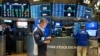 People work on the floor at the New York Stock Exchange in New York, Feb. 27, 2025.