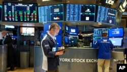 People work on the floor at the New York Stock Exchange in New York, Feb. 27, 2025.