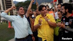 FILE - Lawmakers from the Venezuelan coalition of opposition parties Jose Manuel Olivares (L), Carlos Paparoni (C) and Miguel Pizarro attend a candlelight rally to pay tribute to victims of violence during protests against Venezuelan President Nicolas Maduro's government in Caracas, Venezuela, June 21, 2017. 