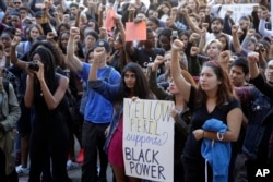 FILE - University California Los Angeles students stage a protest rally in a show of solidarity with protesters at the University of Missouri, in Los Angeles, Nov. 12, 2015.