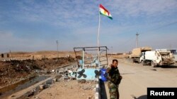 FILE - A member of the Kurdish security forces takes part in an intensive security deployment in Jalawla, Diyala province, Dec. 1, 2014. 