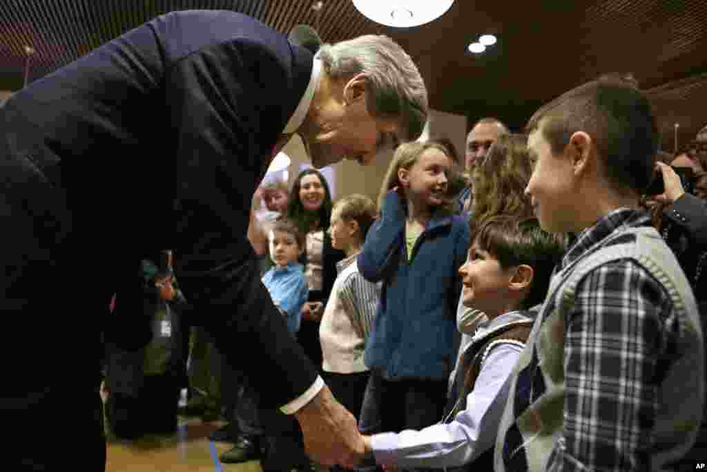 U.S. Secretary of State John Kerry shakes hands with the children of U.S. Embassy staff in Berlin, Feb. 26, 2013. 