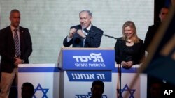 Israeli Prime Minister Benjamin Netanyahu greets supporters at the party's election headquarters In Tel Aviv. Wednesday, March 18, 2015.