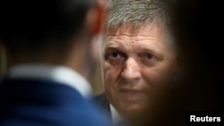 Robert Fico, leader of the SMER-SSD party, speaks with a journalist after a televised debate at TV TA3, prior to the Slovak early parliamentary election in Bratislava