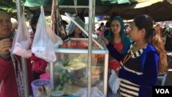 Garment workers buy food during a lunch break on national road #2 in Meanchey district, Phnom Penh, Cambodia. (Photo: Phorn Bopha/VOA Khmer) 