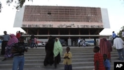 Residents gather outside the reopened National Theater in Somalia's capital Mogadishu, March 19, 2012. In the roofless, bullet-ridden building that houses Mogadishu's National Theater, Somali musicians staged a concert for the first time in 20 years, a si