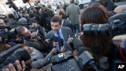 Massimo Carminati's lawyer, Bruno Naso is chased by reporters as he arrives at a court in Rome, Nov. 5, 2015. 