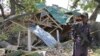 A Somalia soldier stands guard near the destroyed restaurant in Mogadishu, Somalia, Dec. 15, 2016.