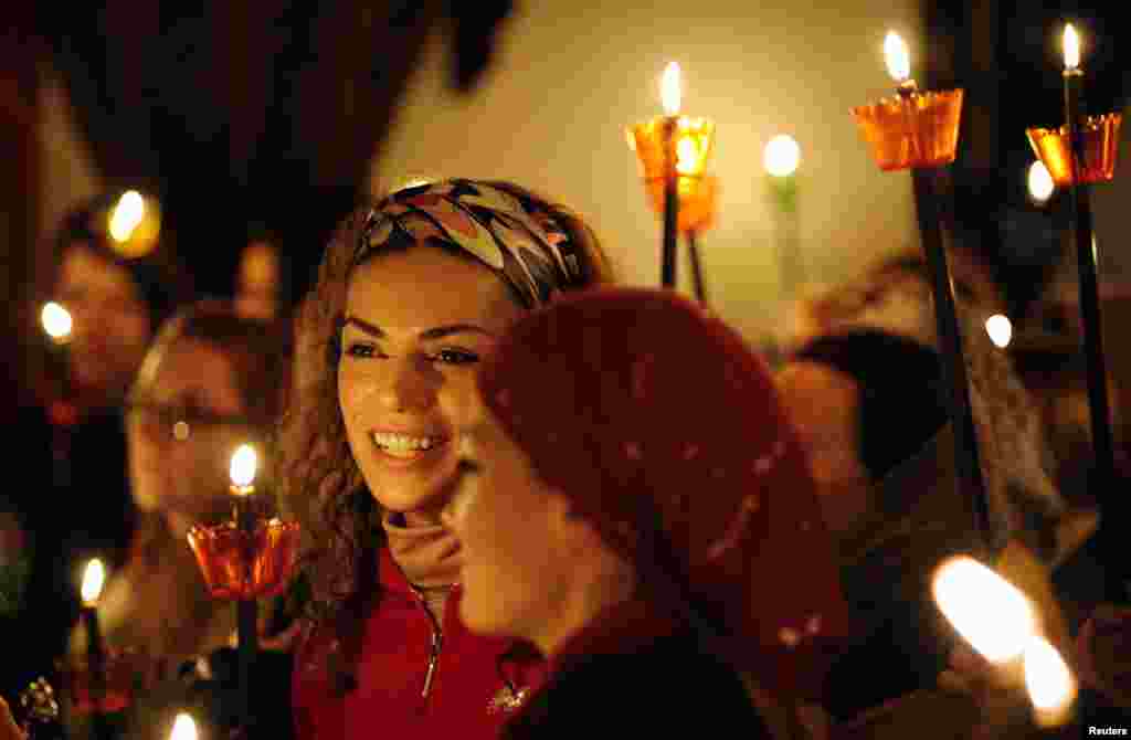 Women attend the Christian Orthodox Easter service at the 10th century St. John the Baptist Monastery near Mavrovo, west of Macedonia's capital Skopje, April 20, 2014. REUTERS/Ognen Teofilovski (MACEDONIA - Tags: RELIGION) - RTR3LY7B