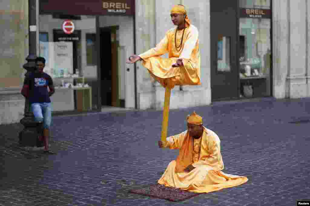 Street artists perform in downtown Rome, Italy.