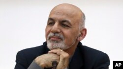 FILE - Afghanistan's President Ashraf Ghani listens to a journalist during a press conference.