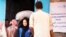 FILE - People in the Yemeni port city of Hudaydah have been provided with vouchers by the World Food Programme which they can exchange for food. (March 2019)