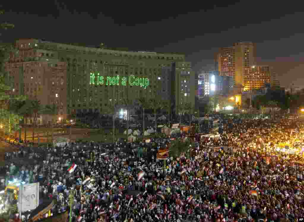 Opponents of Egypt's Islamist ousted president Mohamed Morsi wave national flags as they celebrate in Tahrir Square, in Cairo, July 5, 2013