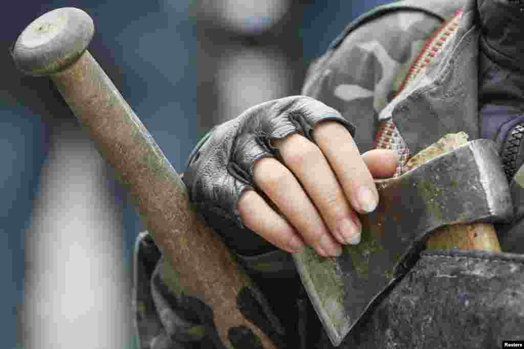 A female member of a &quot;Maidan&quot; self-defense unit stands guard in front of the Ukrainian parliament building in Kyiv, April 15, 2014.