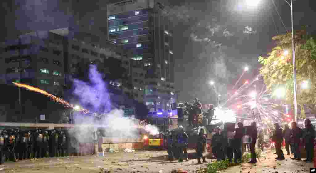 Riot police fire tear gas to disperse students protesting a new law that they said has crippled the country&#39;s anti-corruption agency, during a clash outside parliament in Jakarta, Indonesia.