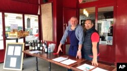 Restaurant owner, Christian Etchebest, left, and his chef Thierry Larallde, who is temporary unemployed, pose in the restaurant La Cantine du Troquet in Paris, April 28, 2020. 