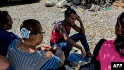 Relatives of people who disappeared in two shipwrecks en route from Venezuela to Trinidad and Tobago on April 23 and May 16, 2019, talk during a meeting in Guiria, Venezuela, on March 13, 2020. 