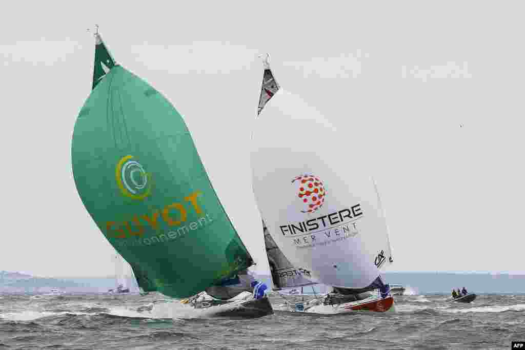 Pierre Leboucher (L) and Eric Peron sail on their monohulls &quot;Guyot Environnement&quot; and &quot;Finistere Mer Vent&quot; as they take the start of the 49th Solitaire URGO - Le Figaro solo sailing race off the coast of Le Havre, northwestern France.