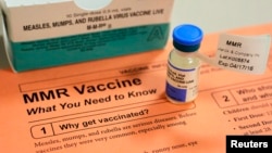 A vial of measles, mumps and rubella vaccine and an information sheet is seen at Boston Children's Hospital in Boston, Massachusetts, Feb.26, 2015. 