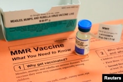 FILE - A vial of measles, mumps and rubella vaccine and an information sheet is seen at Boston Children's Hospital in Boston, Massachusetts, Feb.26, 2015.