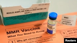 FILE - A vial of measles, mumps and rubella vaccine and an information sheet is seen at Boston Children's Hospital in Boston, Massachusetts, Feb.26, 2015. 