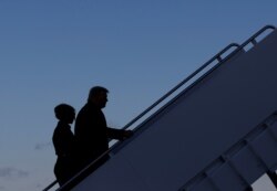 U.S. President Donald Trump departs next to first lady Melania Trump from the Joint Base Andrews, Maryland, Jan. 20, 2021.